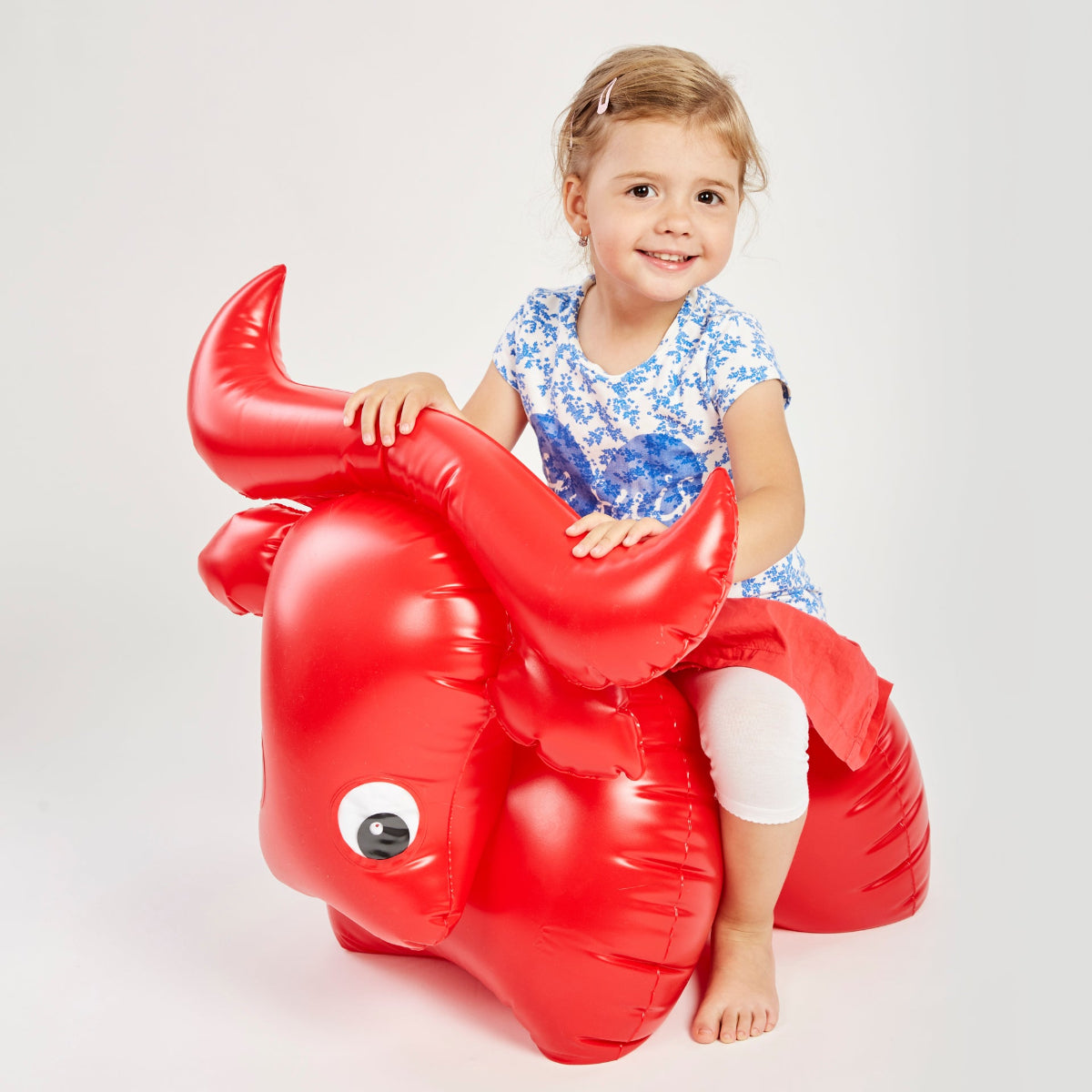 child sitting on the inflatable buffalo