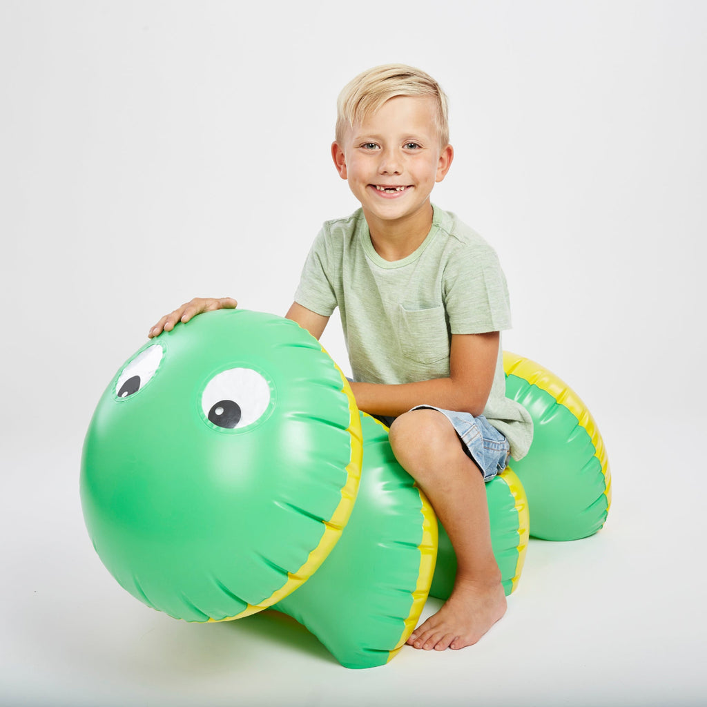 child sitting on the inflatable caterpillar