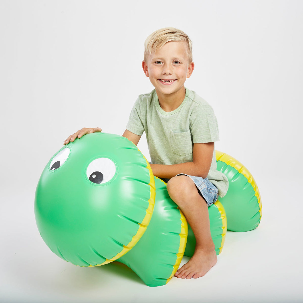 child sitting on the inflatable caterpillar