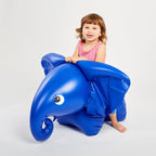 Inflatable elephant with a child sitting on it