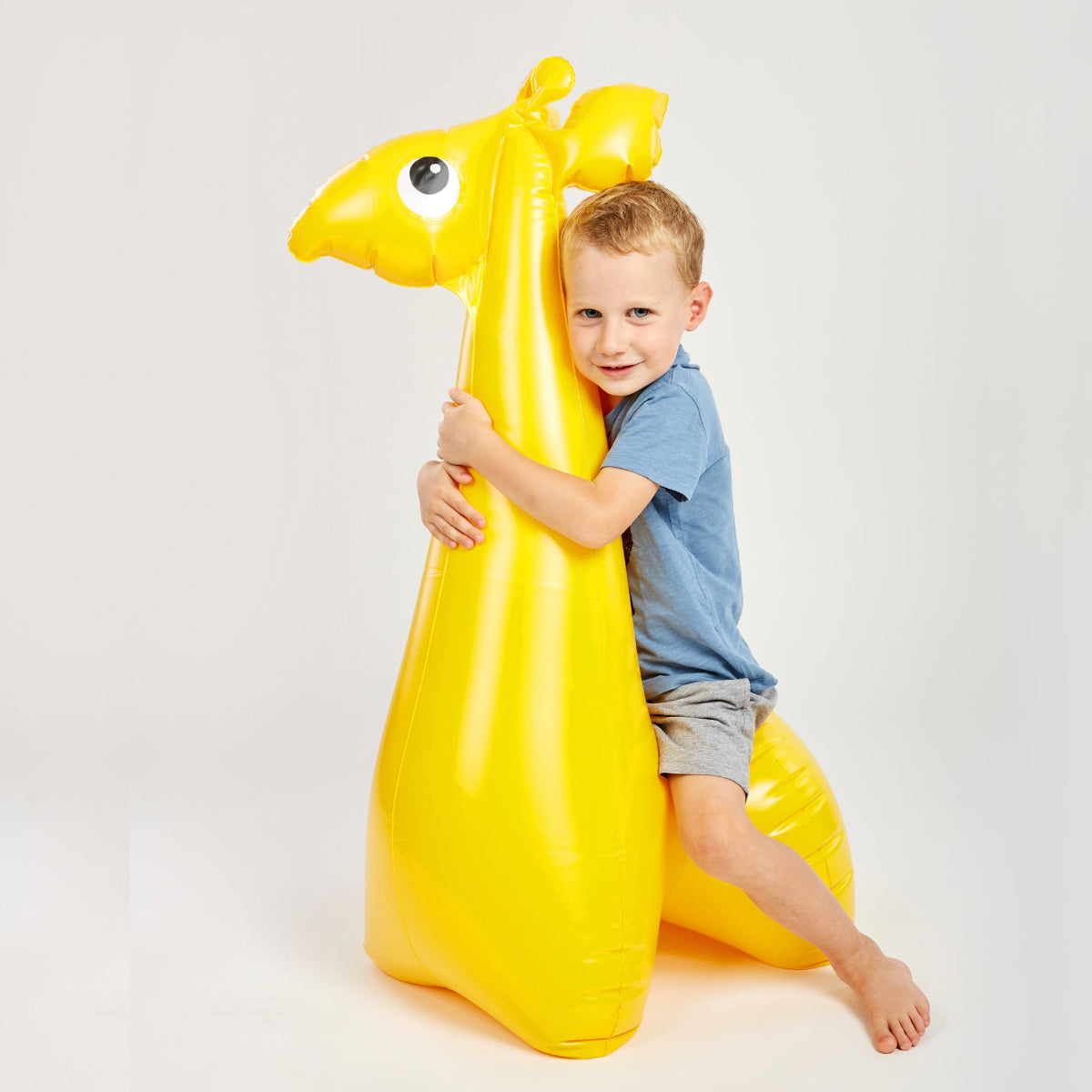 Inflatable giraffe with a child sitting on it